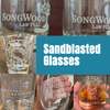 Collage of sandblasted glasses with various designs and text, featuring the brand 'Songwood Law PLLC'.