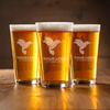 Set of three engraved 16oz pint glasses with etched logos—perfect for bulk corporate orders, onboarding kits, or branded hospitality merchandise.