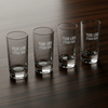Four clear glasses with 'Your Logo Etched Here' text on a wooden surface
