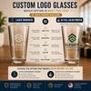 An infographic comparing laser engraved and UV full color printed logo glasses, showing two clear glasses with sample logos on a wooden table against a warm indoor background. The graphic includes text options, pros and cons, and branding for Elevate Solutions.