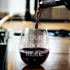 Personalized stemless wine glass featuring a custom logo, staged on an executive desk – ideal for corporate swag, HR appreciation, or branded office barware.